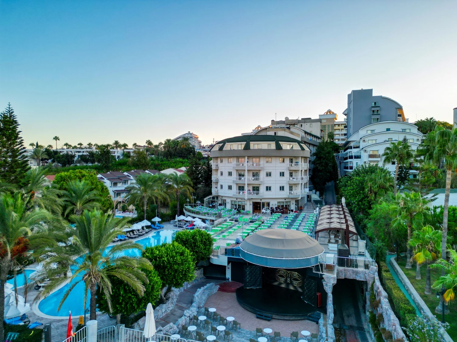 Pools and terraces at Side Sun Hotel at dusk